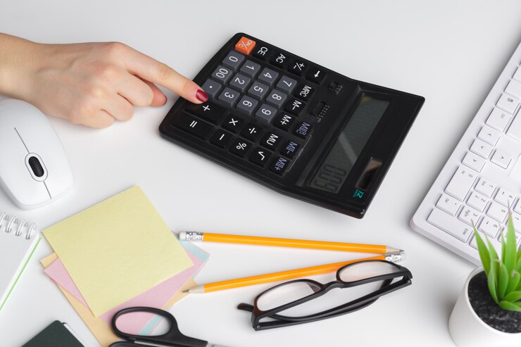 Person using a calculator to estimate mortgage affordability and home financing options in Portugal.